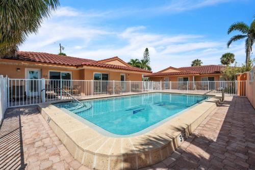 a swimming pool in front of a house at The Villas 2B in Holmes Beach