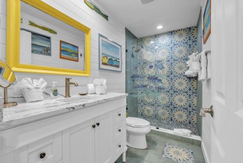 a bathroom with a sink and a toilet and a shower at The Villas 2B in Holmes Beach