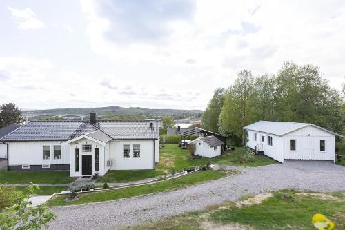 a large white house with a gravel driveway at Island Villa in Sundsvall Alnö in Alnön