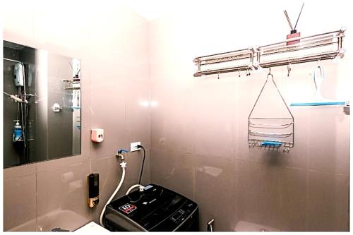 a bathroom with a sink and a mirror at City Best Designer 1BR Makati Fast internet Gym Swim Park 2050 in Manila