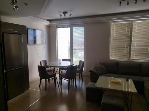 a living room with a couch and a table at Skopje Sky Apartments & Floor 33th 28th & 25th & 19th & 13th 12th With Pool & Spa & Fitness & Parking Included in Price in Skopje