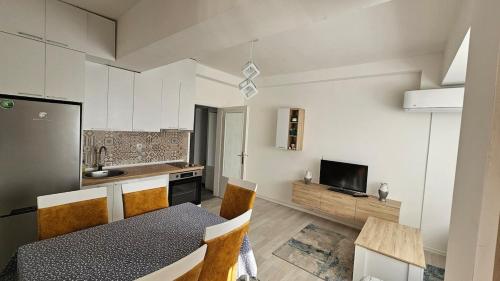 a kitchen and dining room with a table and chairs at Apartment Andrevski in Ohrid