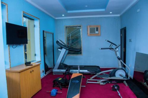 a room with a gym with a treadmill at Zoey International Hotels Ltd in Owerri