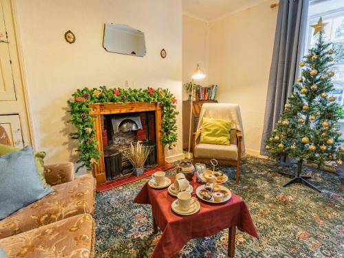 a living room with a christmas tree and a table at Number 4 in Llandeilo