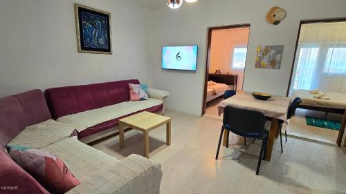 a living room with a couch and a table at Alpha Casa in Bar