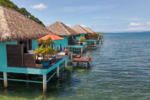 a row of huts on the water near the ocean at Sol Bungalows Bocas del Toro in Bocas del Toro