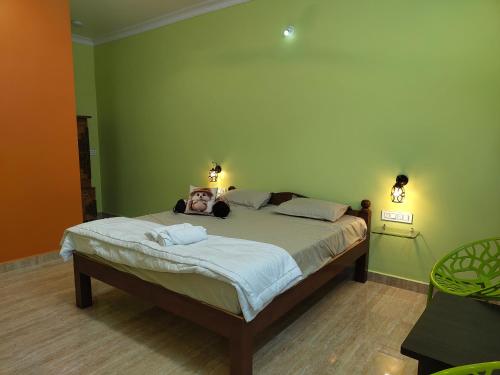 a bedroom with a bed with a person laying on it at Shanthi Guest House in Hampi