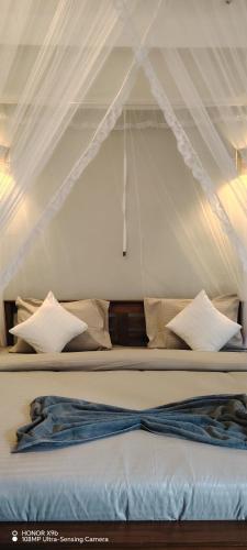 a bedroom with a bed with a canopy at Ella Ceylonka in Ella