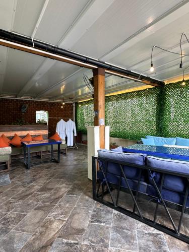 a room with blue tables and a green wall at Maajid Boutique Hotel in Baku