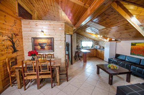 a living room with a table and a couch at The Pearl of the Golan - Pnina BaGolan in Had Nes