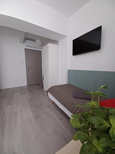 a bedroom with a bed and a flat screen tv at Villa Marina in Augustów