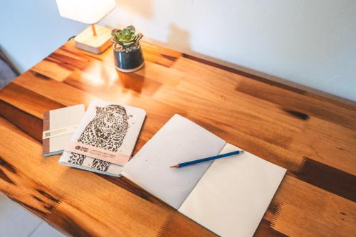 a table with a book and a pen on it at Taki Tambo Lodge in Tarapoto