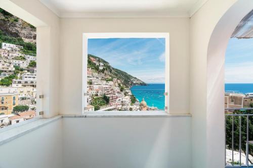 a room with a window with a view of the ocean at Villa Magia in Positano