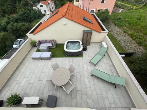 an aerial view of a patio with a table and chairs at Villino con terrazzo panoramico in Finale Ligure
