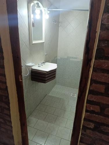 a bathroom with a sink and a mirror at Cabañas Postal de la Villa in Villa Carlos Paz