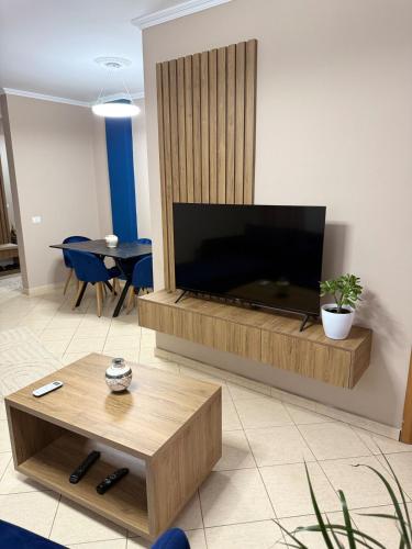 a living room with a large flat screen tv at Urban View Tirana in Kashari