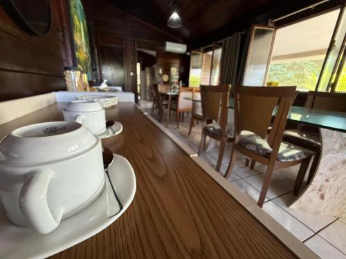 a cup of coffee sitting on a table in a room at Pousada das Flores in Fernando de Noronha