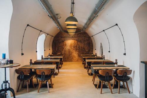 a row of tables in a room with a wall at Hotell Moe 