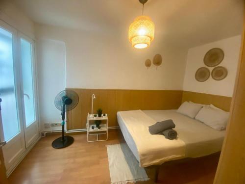 a bedroom with a bed and a lamp and a window at Plaza Guest House in Madrid