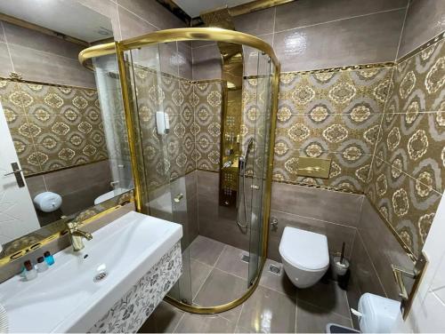 a bathroom with a shower and a sink and a toilet at Centro Park Hotel in Uzungöl