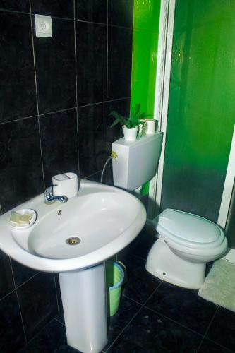 a bathroom with a sink and a toilet at Hotel Pousada Venus in São Filipe