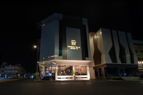 a large building at night with its lights on at Grand day in Al Hofuf