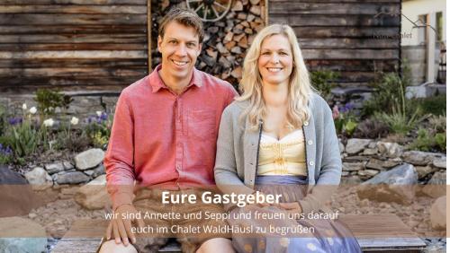 a man and a woman posing for a picture at Chalet WaldHäusl luxuriöse Ferienwohnungen mit Sauna & Whirlpool, Kamin, Balkon oder Terrasse mit Bergblick in Heiligenblut