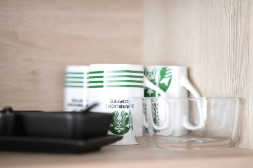 a group of coffee cups sitting on a table at Luxury Bayview Apartment Tivat in Tivat