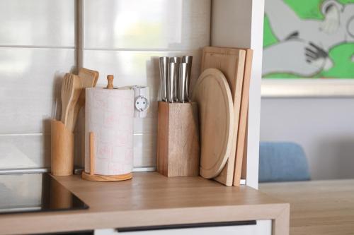 a group of wooden utensils sitting on a shelf at Luxury Bayview Apartment Tivat in Tivat
