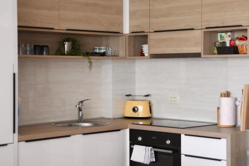 a kitchen with a sink and a counter top at Luxury Bayview Apartment Tivat in Tivat