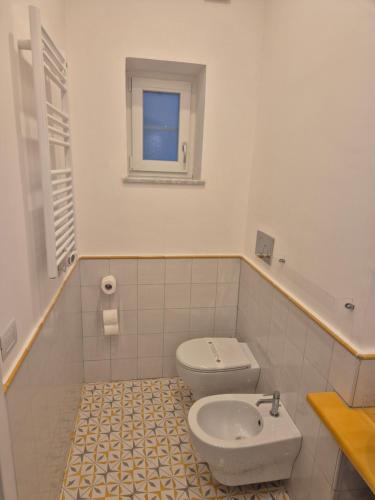 a bathroom with a toilet and a sink at Hotel Villa Annalara charme and Relax in Amalfi