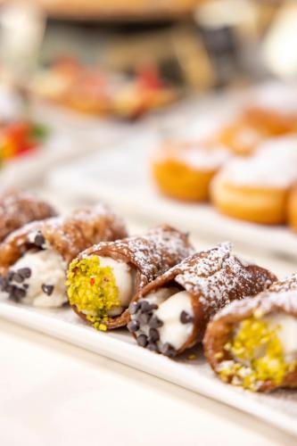 a white plate of pastries on a table at Hotel Villa Paola in Rimini