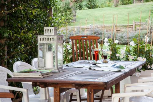 a wooden table with white chairs around it at Il Giuggiolo - holiday homes in Fossombrone