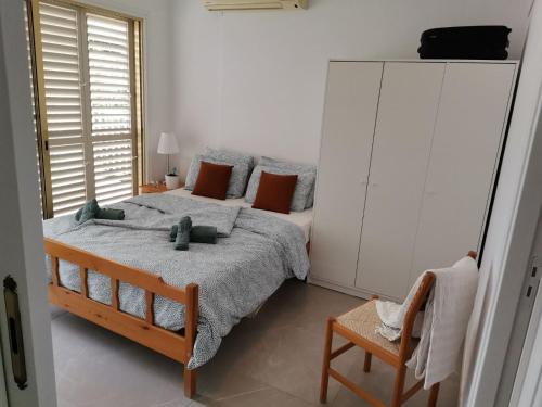 a bedroom with a large bed and a chair at Apartment Sun Kapparis in Paralimni