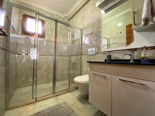 a bathroom with a shower and a toilet and a sink at Sea View Fethiye in Fethiye