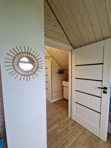 a hallway with a door and a mirror at Chill Chaty in Tarnobrzeg