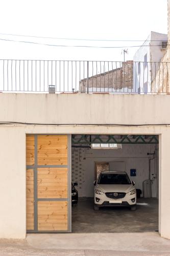 a car parked inside of a garage with a car parked at Casa Rural Boutique - Ca Bolo in Pinell de Bray