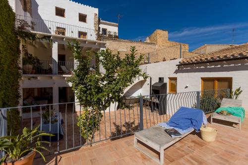 a patio with a bench and a building at Casa Rural Boutique - Ca Bolo in Pinell de Bray