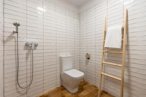 a bathroom with a toilet and a shower at Casa Rural Boutique - Ca Bolo in Pinell de Bray