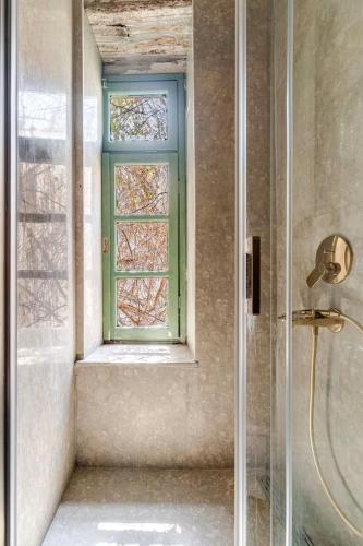 a bathroom with a shower and a window at Mediha Hanım Konağı Alaçatı in Cesme