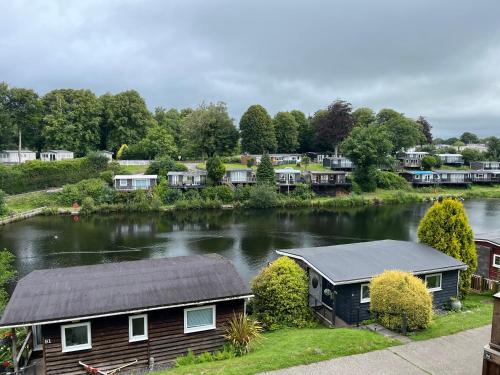 a house next to a river with houses at Summit Rest in Caeathro