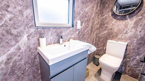 a bathroom with a sink and a toilet at Whitemills Wake and Aqua Park Lodge Two in Richborough