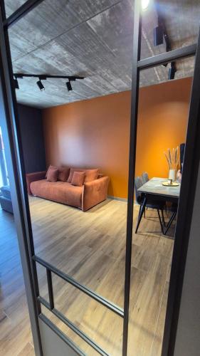 a living room with a couch and a table at Apartament Baltic 13 Mielno in Mielno