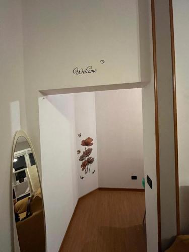 a hallway with a mirror and a sign on the wall at Dream's Tower BO in Bologna