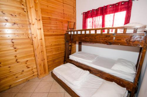 two bunk beds in a room with a window at The Pearl of the Golan - Pnina BaGolan in Had Nes