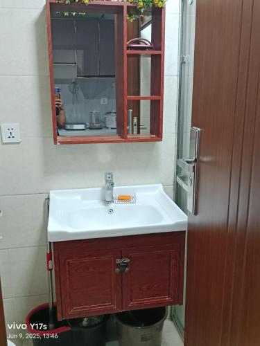 a bathroom with a white sink and a mirror at Megatower 3 condotel in Baguio