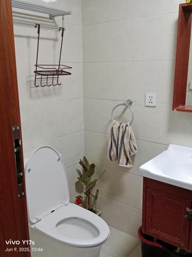 a bathroom with a white toilet and a sink at Megatower 3 condotel in Baguio