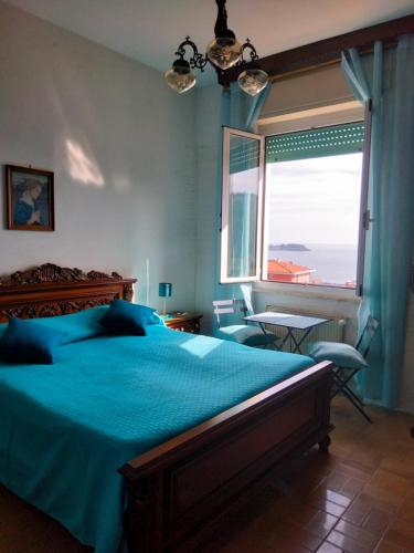 a bedroom with a bed and a large window at Appartamento Miramare in Lerici
