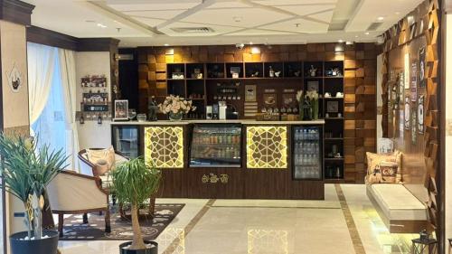 a room with a bar with a counter and chairs at East Diamond Serviced Apartments in Jeddah