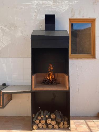 a fireplace with a fire inside of it at Casa Rural Boutique - Ca Bolo in Pinell de Bray